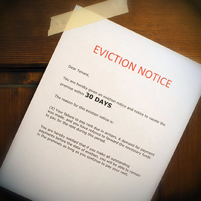 An eviction notice taped to a front door of a rented property