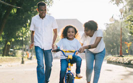family with child on bike