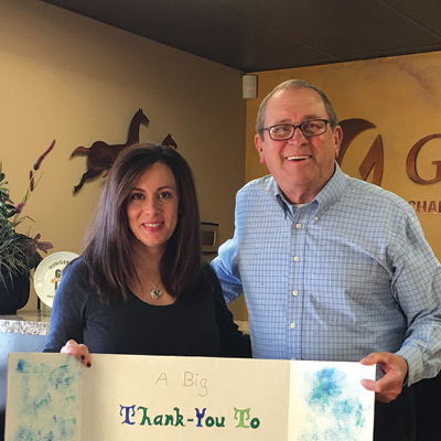 Glenn presents a thank you card to Sarah Watts of the Gilbert Chamber of Commerce, one of our supporters