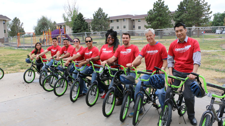 Janus Henderson Investors employees, lined up on the bikes they built