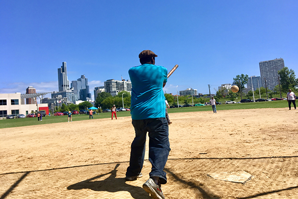 a man hits a softball