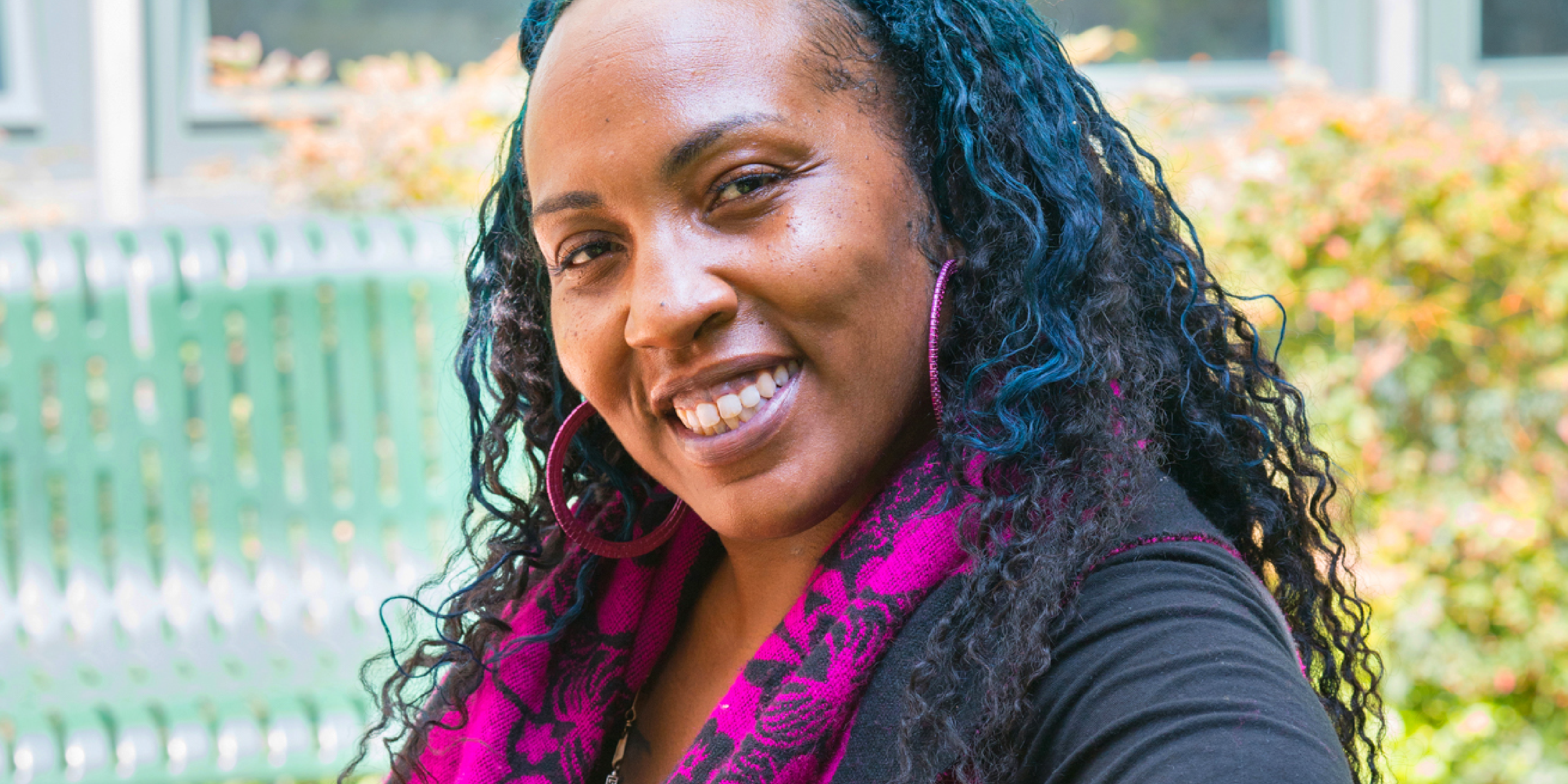 Headshot of smiling woman, Kai Bluford, who is our Resident Services Coordinator