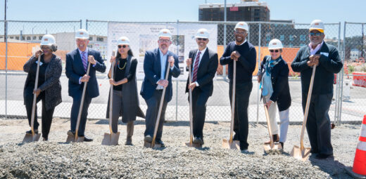 A group of people with hard hats and shovels