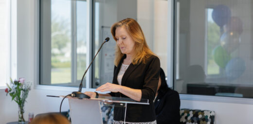 Cerise speaking at a podium